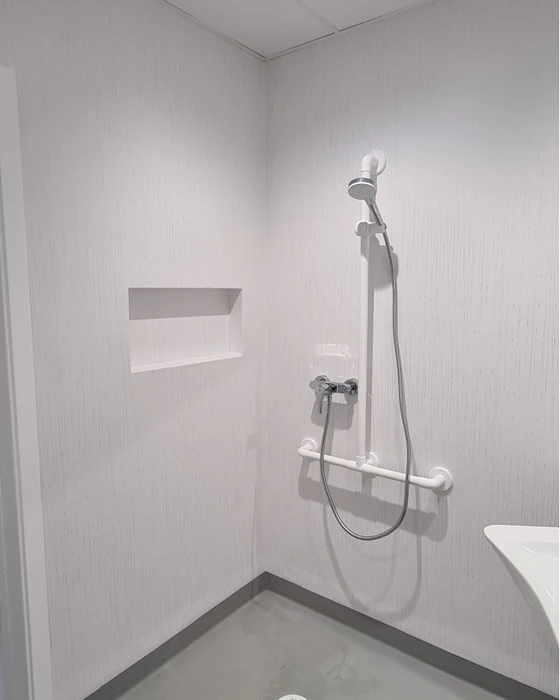 homme à main cachant un câble avec un plinthe